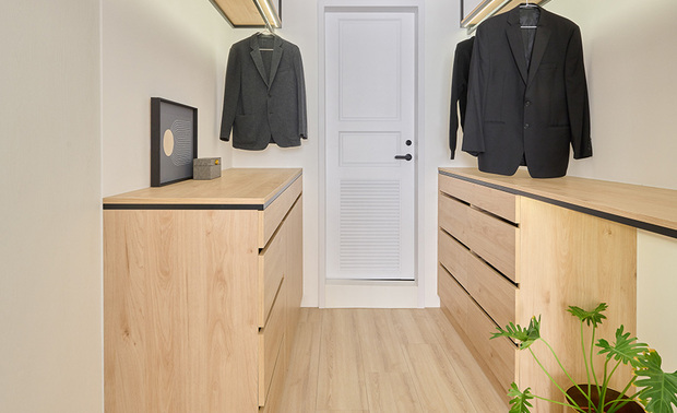 主卧、更衣间
Mater bedroom and walk-in closet

床头牆以浅灰为主色调，搭配白色床背板，做为上方纯白大樑的延伸，两侧悬空的皮革床头柜，结合暖色线灯，于主卧打造温润感受；更衣间设置牢固铁架方便吊挂衣物，木质柜体则延续卧室温馨舒适的氛围，兼具收纳机能。

The light-grey back wall merrily complements the white headboard, and the suspended leather bedside tables with chic sconces gently create a balmy ambiance in the master bedroom. We install iron-hanging rails and wood dressers in the walk-in closet, which are handy for organizing clothes and correspond to the pleasant situation of the bedroom.

