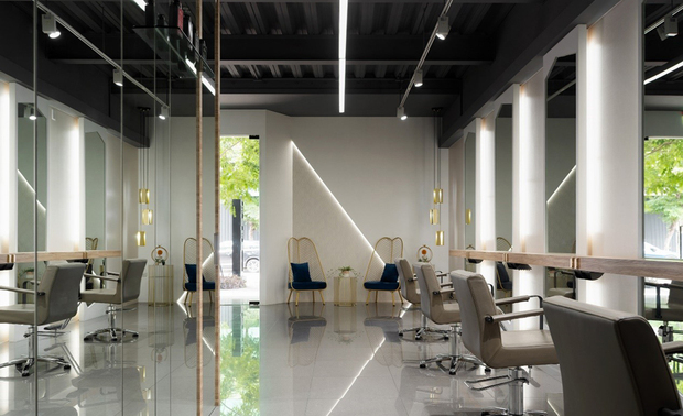 一楼工作区
Workspace-The First Floor

一楼工作区利用原天花板只做铁灰色颜色变更，形塑现代俐落感，入门左侧置入澹金色的质感软装作为等待区，让候位服务的客人在此暂歇，深入内部，剪髮区后的柜子陈贴镜子，进一步增加反射面，邻接的洗头区减少上方直射灯光、设立饰有木条的长虹玻璃隔屏取代布帘，壁面则藉相同造型的木质元素相呼应，提升整体性。

On the 1st floor, the existing ceiling applied to a gray metal color sleekly shapes a modern interest. Pale golden furnishings on the left of the door accommodate a waiting zone. In the further room, the mirrored-front cabinet, behind the styling chairs, elevates reflective spaces. On the other hand, no direct lighting shines above the wash stations. In addition, an integral design applied with wood strips appears on the fluted glass partition and the wall. 