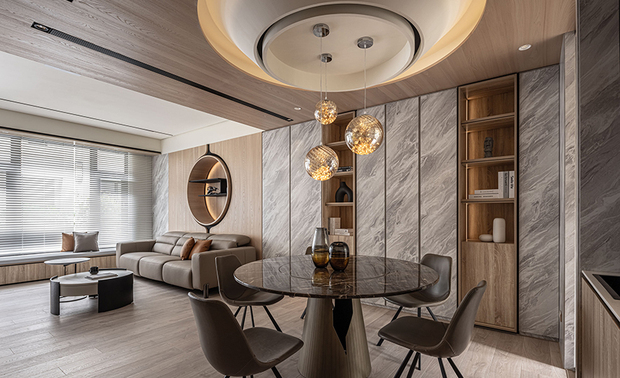
本文由OPEN编辑部撰写

设计概念 Design Concept

自然化育万物生长，如同一幢包容三代同堂生活的家宅，推门入内，石纹描绘的山岚萦绕在木质周遭，彷彿可嗅到湿凉雾气，灰白间隙隐约透出朦胧薄光，呈递长空将亮，流云渐明之景，蕴藏迎接美好日升的期盼，引人进入一片惬意天地。

集结业主对交谊、孝亲和未来成家等多方面的嚮往，峥嵘设计 廖峥 廖嵘 设计师 将自然孕育万物、大海容纳百川的包容意象定为家宅主题，撷取明媚晨光与高山雾岚的景緻挹入宅邸，辅以木、石、铁件等元素，构筑出家庭成员各自喜爱的风格，同时展现各场域独特性，赋予美学和舒适并蓄的自适氛围。

Mother nature nurtures all living creatures, just like a comprehensive home design that fits for three generations. Veined marble imitates the mountain mist floating around the wood surfaces, and it seems that you can smell a bit of cool air. Hazy light penetrates between the grayish slabs as the morning sun shines through the clouds. The poetic image performing a fresh start of a nice day, leads people into a comforting field.

Integrated the ideals of recreation and a multi-generation family, C.J.HOUSE DESIGN designers Cheng Liao and Jung Liao decided the project theme on a portrait that Mother Nature receives all living creatures. Bring morning sunshine and mountain mist to the interior; we utilize wood, stone, and metal to perform exclusively preferable styles. Besides, distinctively featured spaces deliver an aesthetic and cozy atmosphere in each respective way.

设计手法 Design Techniques

自然意象 现代质韵
Biophilic Design & Modern Motifs

以「山岚晨光」为主题，我们运用浅色大理石纹表现晨雾色彩，间接照明象徵和煦晨曦，形塑明亮大气的公领域，再搭配线条俐落的铁件，展现业主喜爱的现代风格，而足下散发暖意的木质地坪，则营造长辈中意的温馨感受。

To reveal the image of veiling mountain mist and morning sunlight, we take light-shaded marble veining as the mist and let the reflective lighting play the balmy morning sunshine. The grand design of the bright public space with sleek metallic fixtures performs a modern style that meets the homeowner's preference. Additionally, the warm-touched wood flooring satisfies the elders' wishes.

通透场域 便利机能
Open Layout & Facilitated Equipment

回应业主招待亲朋好友的需求，一楼规划为开放式公领域，提供人们尽情交流的宽敞空间，客厅中装设7.1声道的影音系统，为访客及居者带来优秀的视听体验；私领域将主卧兼作书房，床尾配置结合电视牆的书桌，让从事科技业的屋主能舒适地居家办公，也可自在切换工作和休閒模式。

To the need for recreation, we created an open layout on the ground floor, providing abundant public space. Besides, a 7.1 surround home theater system presents an excellent cinematic experience. In the private area, we built a master bedroom with a home office. The built-in desk attached to the half-wall divider allows the homeowner to work and relax at home.

健康无毒 长远规划
Healthy & Future-Proof Plans

思及业主将来三代同堂的人生规划，本案划设一间孝亲房、两间孩童房和一座电梯，提前为年迈长辈备好安全的上下楼路径，同时方便未来搬运婴儿推车等大型物件，此外，全案皆使用绿建材标章的材料，自根本处守护每位居者的健康。

The project aimed to incorporate three generations under the same roof. First, we planned a grandparent room and two kids' bedrooms. Moreover, we built an elevator that facilitated the elders to move up and down floors and carry large items such as baby strollers. In addition, we crucially preserved the residents' health by adopting the green-labeled standard building materials for the entire project.
