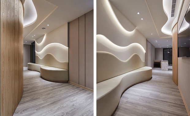 
候诊廊道
Corridor of reception area

抽血区曲线的木皮外牆，让外部候诊空间显得更有生气、柔和等待的气氛，同时呼应牆壁和天花板的造型，而空调出风口的曲折样态，亦与整体设计概念一致。

The blood drawing area wall of wavy pattern brings a lively vibe and soothes the anxiety mood of the exterior waiting area. And, consistent with the overall design concept, the air conditioning outlet is arranged on the ceiling in a curvy pattern.

项目资讯

案名：煦光蕴玉
项目类型：商业空间
项目地址：台湾台北
设计团队：简兆芝室内设计
项目坪数：288坪
主要建材：木皮、镀钛板、大理石、石塑木地板、壁布、皮革、小冰柱玻璃

简兆芝
简兆芝室内装修设计有限公司　主持设计师(建筑师)
电话：+886-2-2500-0653
地址：台北市中山区民生东路三段17号2楼
网址：http://inkdesignspace.com/

OPEN Design 动能开启传媒：http://www.openworld.tv/talk/