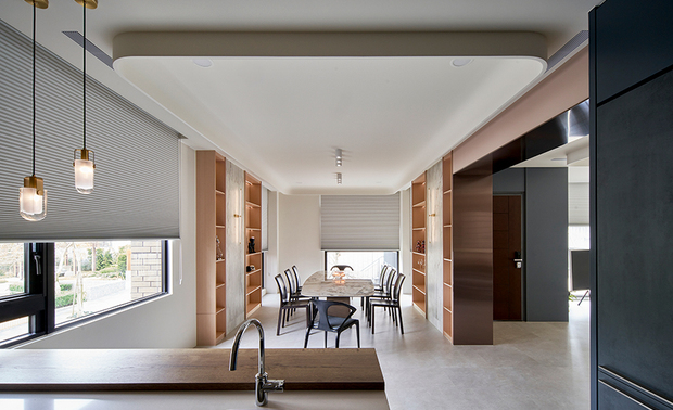 
餐厨区
Kitchen & Dining Space

餐厅与开放式厨房相连，L型厨具嵌入浅灰铺砌牆面，搭配铁件层架，打造简约俐落的烹饪场域；中岛结合吧台，上方佈置错落有致的吊灯，成为此区的视觉焦点，不只作为轻食区或工作台面，也是餐厨区的多功能互动核心。餐桌选用石材桌面搭配木作桌脚，质朴温润；穿透的橱窗引入庭院翠意，小巧的圆形灯具映照长桌，光影变化间充满自然意趣，呼应「禅意休閒宅邸」的调性。

A light gray marble wall sets off the L-shaped kitchen furniture with metallic shelving, delivering a versatile cooking space that coheres to the dining room. Besides, the breakfast bar provides a space for light meals or a workplace, and it also contributes to an interactive hub, revealing an accent with charming pendant lights. Appealingly, the stone-top dining table with wood plinth displays pristine and elegant textures. Moreover, the transparent shelving invites greenery from the yard as the nifty down adorns the space. Natural attractions echo lights and shadows and coordinate a Zen-style cozy home.

