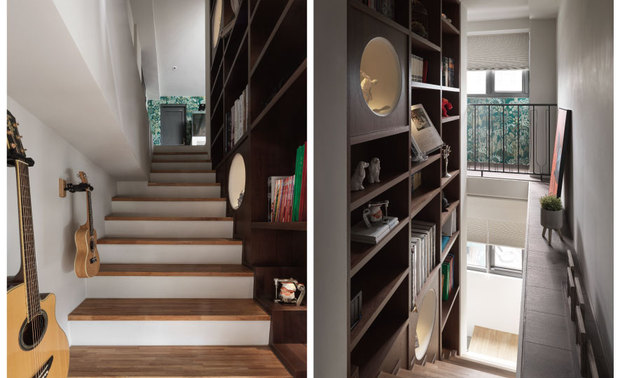
楼梯间──擎天书牆酿艺文趣味 过渡区域摇身化作休閒长廊

顶天电视牆不仅作为公领域与楼梯间的区隔，也利用后方牆面创造木韵满溢的书牆与收纳展示区，配合对面铺设木质地坪、成为展示平台的横樑，与樑下乐器牆的划设，使原本仅是过渡区的单调走道，转作一座和暖舒惬的艺廊，随着每日生活变化，轻鬆更换两侧的佈置摆饰，成为一家人积累回忆时光的长廊，为日常增添艺术品味与情感连结。
