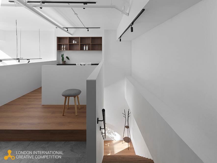 ▲以柔和圆弧语彙，施作于门框造型与入口主视觉牆，搭配内外呼应的光氛引导，形塑温润且具引导性的立面表情；圆角转折不仅柔化既有稜线，更与室内弧形牆面相互呼应，创造由外而内的连续视觉节奏。
